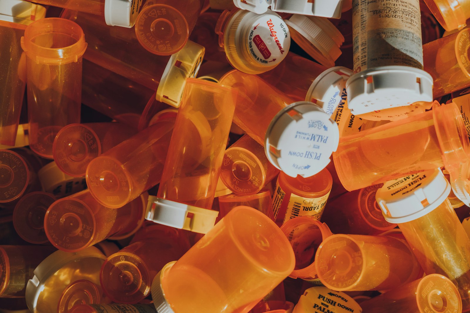 a pile of orange prescription bottles