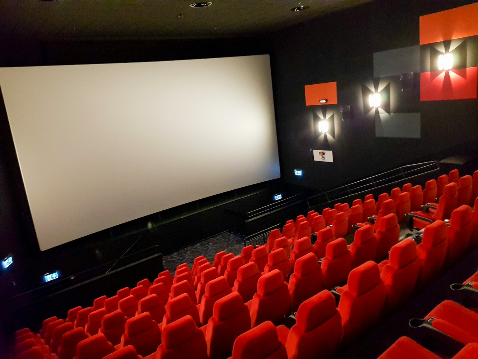 empty theater seats facing a blank screen