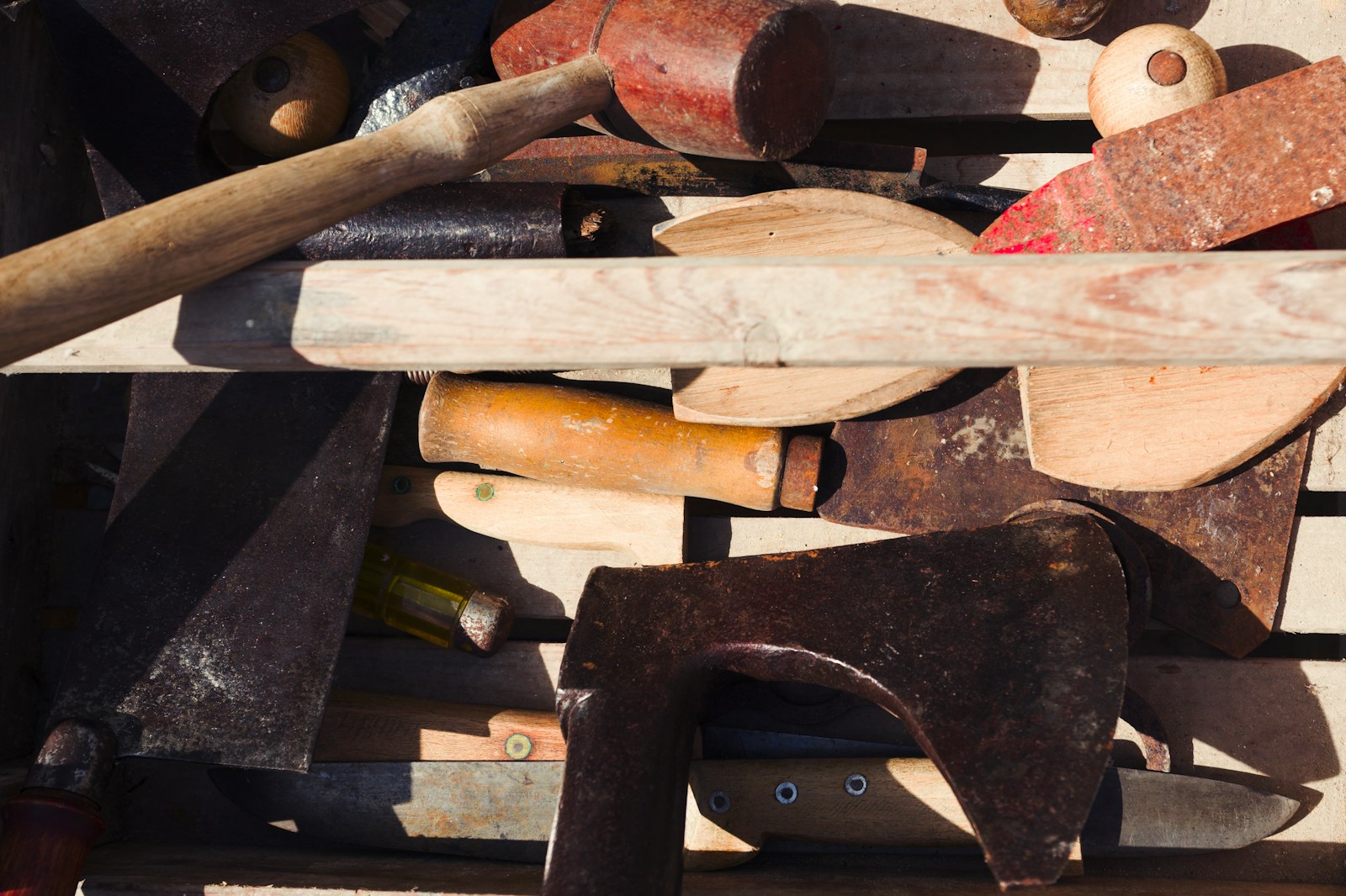 a worn wooden toolbox full of old tools