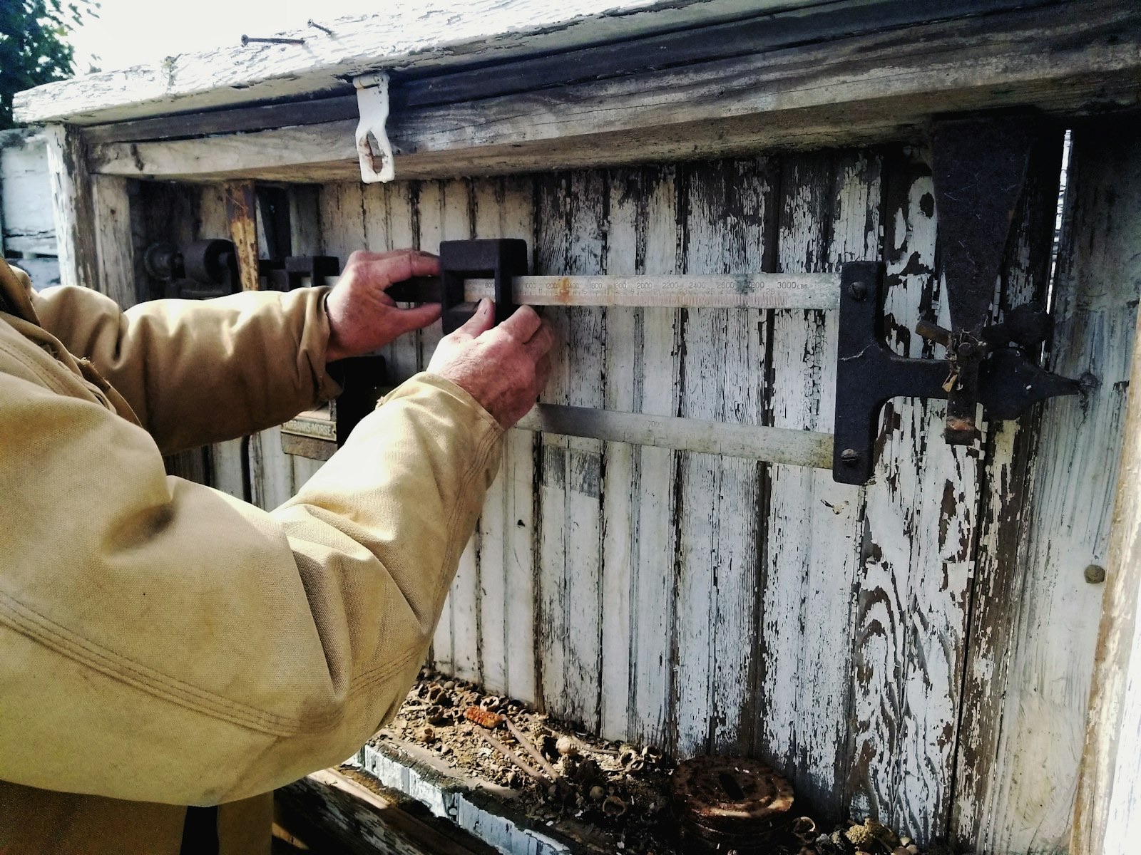 hands adjusting an old balance scale